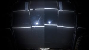 The hood of an Astin Martin Vantage before and after paint correction.