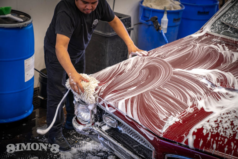 Agitating suds on a 1967 Candy Apple Red Pontiac GTO with a synthetic wool wash pad..