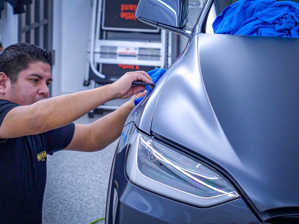 Matte PPF being installed on a Tesla Model X Plaid.